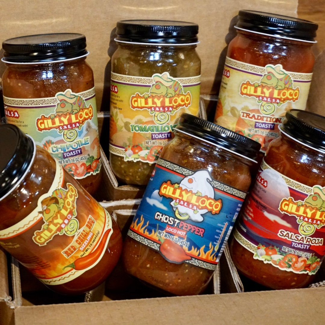 Assorted jars of Gilly Loco salsa and New Mexico chile, highlighting the vibrant colors and fresh ingredients sourced from local New Mexico farms