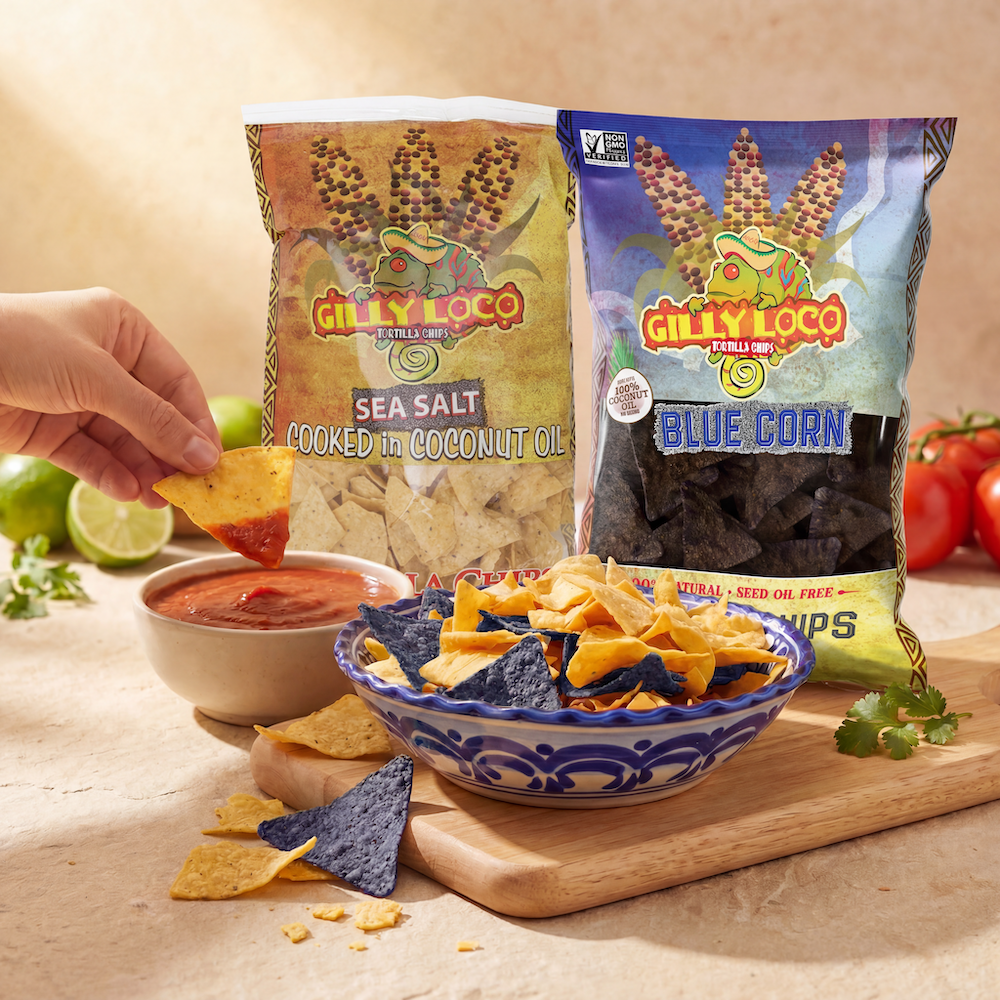 Gilly Loco blue corn and sea salt tortilla chips with a bowl of chips and salsa on a wooden board.