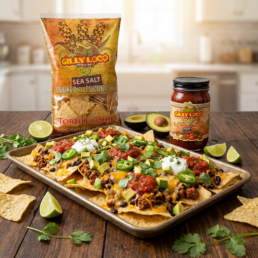 Loaded nachos made with Gilly Loco Sea Salt Tortilla Chips topped with melted cheese, beef, black beans, jalapeños, avocado, sour cream, and Traditional Salsa on a rustic wooden table.